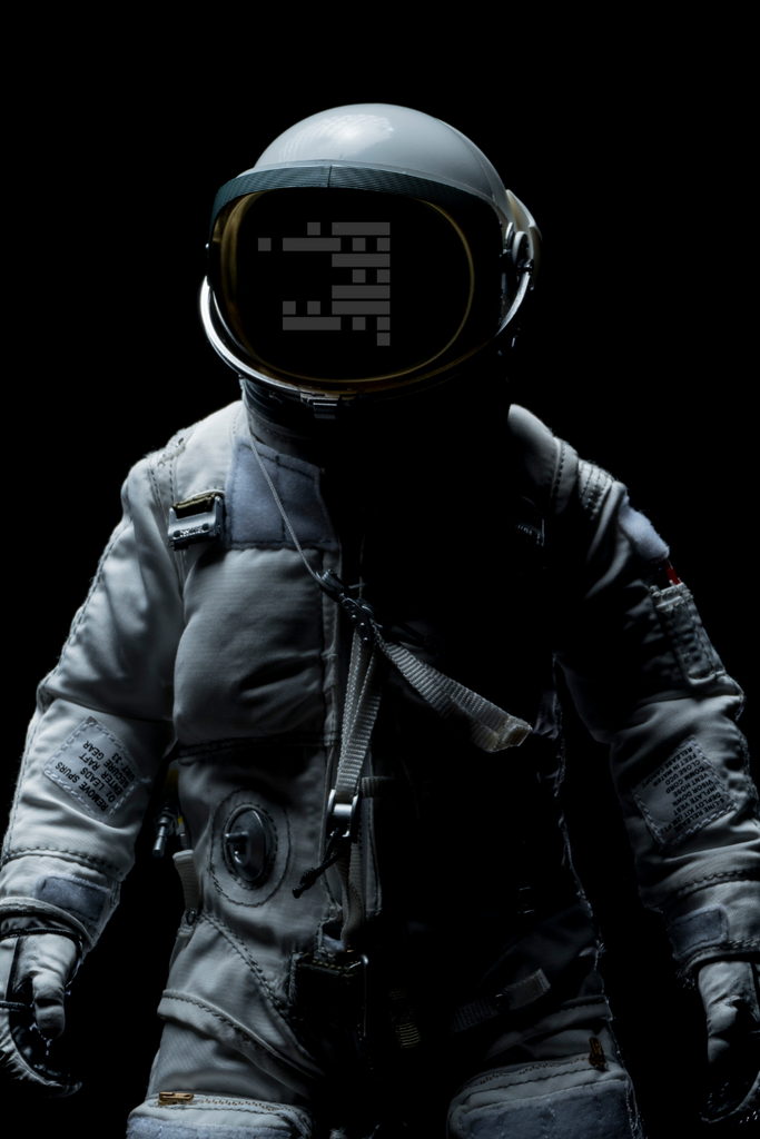 Person wearing a detailed astronaut suit with a black background